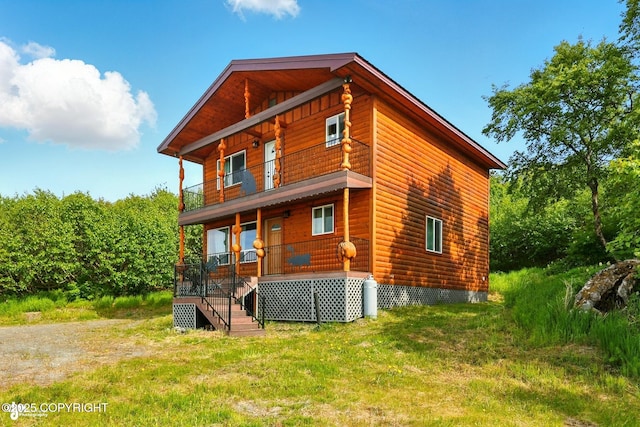 22045 Becharof Cir, Kasilof, AK 99610 - rear view of property featuring covered porch and faux log siding