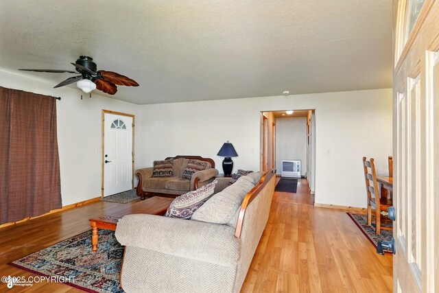 22045 Becharof Cir, Kasilof, AK 99610 - living area with ceiling fan, light wood-type flooring, baseboards, and heating unit
