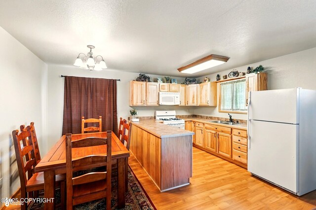 22045 Becharof Cir, Kasilof, AK 99610 - kitchen featuring white appliances, a sink, a chandelier, light brown cabinetry, and light wood-style flooring