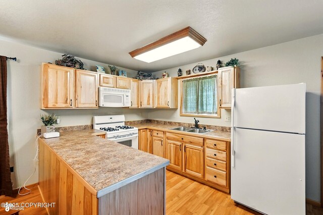 22045 Becharof Cir, Kasilof, AK 99610 - kitchen with white appliances, a sink, light brown cabinets, light wood finished floors, and a peninsula
