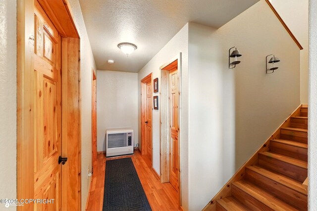 22045 Becharof Cir, Kasilof, AK 99610 - hall featuring heating unit, light wood finished floors, stairs, and a textured ceiling