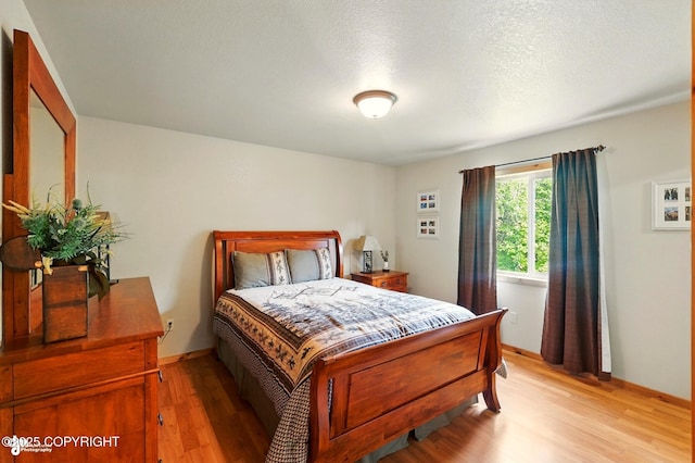 22045 Becharof Cir, Kasilof, AK 99610 - bedroom featuring light wood-style flooring and baseboards