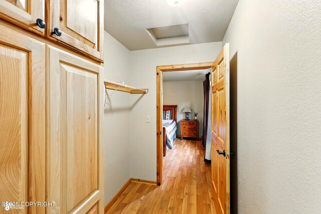 22045 Becharof Cir, Kasilof, AK 99610 - hall featuring light wood-type flooring, baseboards, and attic access