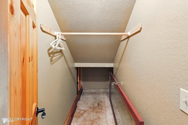 22045 Becharof Cir, Kasilof, AK 99610 - stairway featuring unfinished concrete flooring, a textured wall, and a textured ceiling