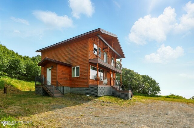 22045 Becharof Cir, Kasilof, AK 99610 - view of side of home with a porch and faux log siding