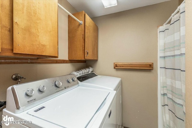 laundry room with cabinet space and washer and clothes dryer