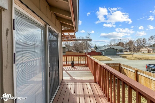 deck featuring fence and a residential view