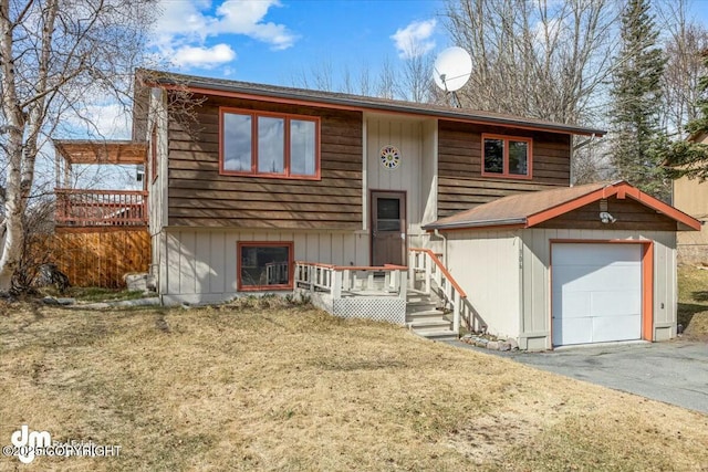 bi-level home with aphalt driveway and a garage
