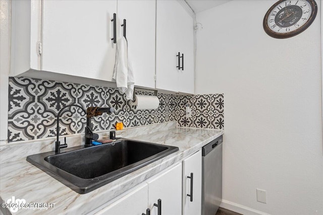 3936 W 88th Ave, Anchorage, AK 99502 - kitchen with baseboards, white cabinetry, decorative backsplash, stainless steel dishwasher, and a sink