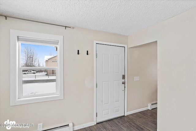 3936 W 88th Ave, Anchorage, AK 99502 - entrance foyer with baseboards, a textured ceiling, wood finished floors, and baseboard heating