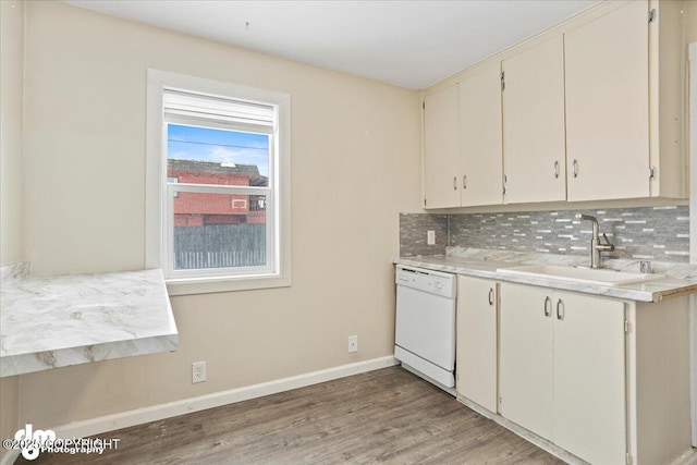 3936 W 88th Ave, Anchorage, AK 99502 - kitchen with white dishwasher, baseboards, a sink, and backsplash