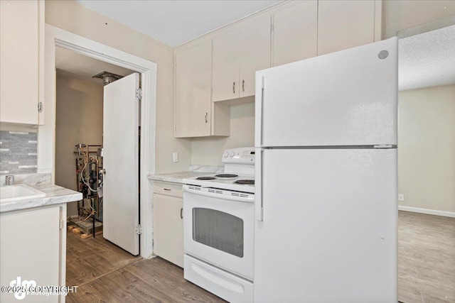 3936 W 88th Ave, Anchorage, AK 99502 - kitchen featuring white cabinets, light countertops, white appliances, and wood finished floors