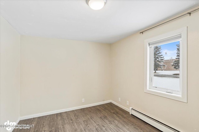 3936 W 88th Ave, Anchorage, AK 99502 - spare room with a baseboard radiator, wood finished floors, and baseboards