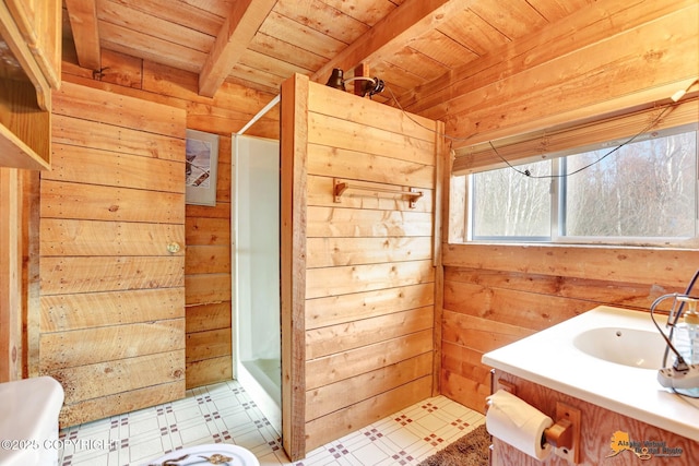 bathroom with beamed ceiling, a shower stall, wooden ceiling, wood walls, and tile patterned floors