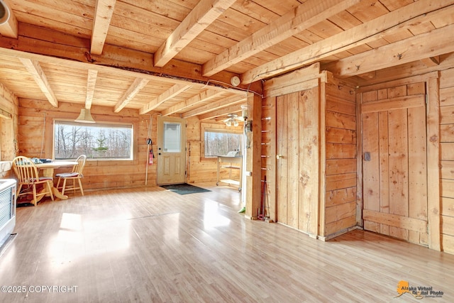 foyer entrance featuring wood walls, wooden ceiling, wood finished floors, and beamed ceiling