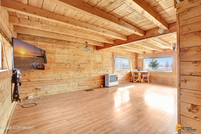 additional living space with wood ceiling, wood finished floors, wood walls, and beam ceiling