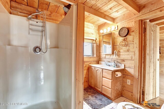 bathroom featuring vanity, walk in shower, wood walls, beamed ceiling, and wooden ceiling