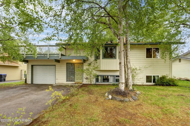 3550 Kachemak Cir, Anchorage, AK 99515 - view of front facade with a balcony, asphalt driveway, a garage, and a front yard