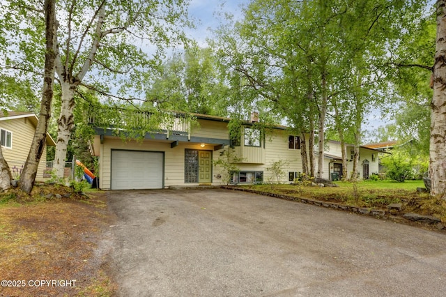 3550 Kachemak Cir, Anchorage, AK 99515 - view of front of house featuring driveway and a chimney