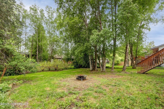 3550 Kachemak Cir, Anchorage, AK 99515 - view of grassy yard with a fire pit and stairs