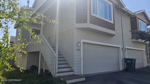 6244 Ophir Dr, Anchorage, AK 99504 - view of property exterior featuring stairs and a garage