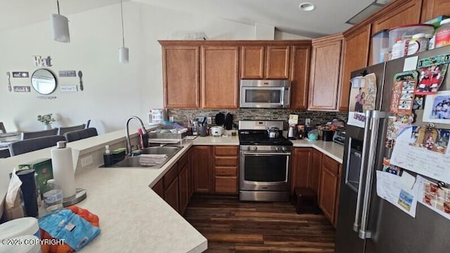 6244 Ophir Dr, Anchorage, AK 99504 - kitchen with stainless steel appliances, light countertops, vaulted ceiling, dark wood-style flooring, and brown cabinetry
