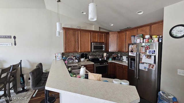 6244 Ophir Dr, Anchorage, AK 99504 - kitchen with appliances with stainless steel finishes, vaulted ceiling, light countertops, backsplash, and a peninsula