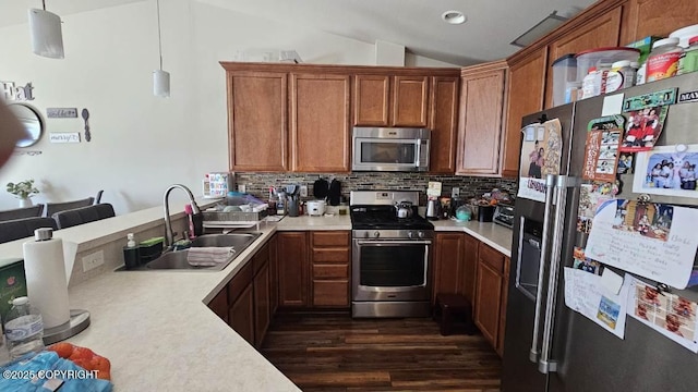 6244 Ophir Dr, Anchorage, AK 99504 - kitchen with appliances with stainless steel finishes, light countertops, vaulted ceiling, tasteful backsplash, and dark wood-style flooring