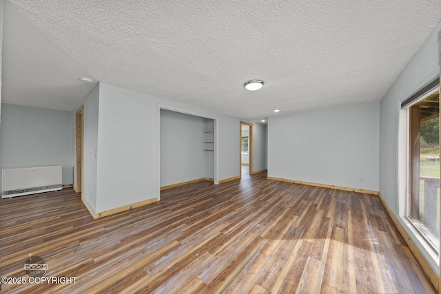 8153 Stewart Mountain Dr, Eagle River, AK 99577 - basement featuring wood finished floors, baseboards, and a textured ceiling