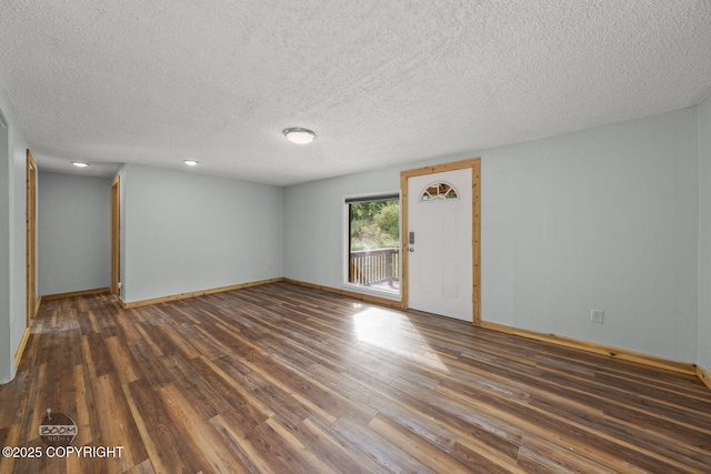 8153 Stewart Mountain Dr, Eagle River, AK 99577 - empty room with wood finished floors, a textured ceiling, baseboards, and recessed lighting