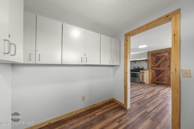 8153 Stewart Mountain Dr, Eagle River, AK 99577 - spare room with dark wood-style flooring, baseboards, and a textured ceiling