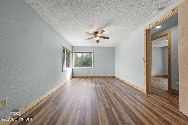 8153 Stewart Mountain Dr, Eagle River, AK 99577 - spare room featuring wood finished floors, ceiling fan, a textured ceiling, a textured wall, and baseboards