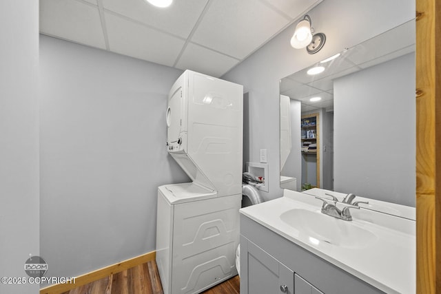 8153 Stewart Mountain Dr, Eagle River, AK 99577 - bathroom with a paneled ceiling, stacked washing machine and dryer, wood finished floors, vanity, and recessed lighting