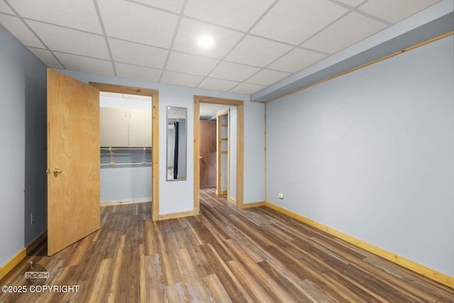 8153 Stewart Mountain Dr, Eagle River, AK 99577 - unfurnished bedroom featuring baseboards, wood finished floors, a paneled ceiling, and a closet