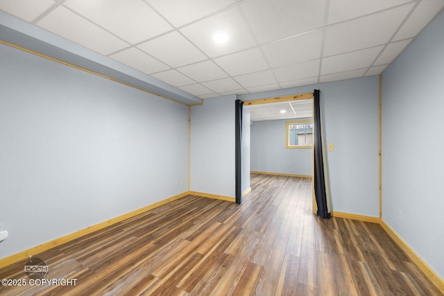 8153 Stewart Mountain Dr, Eagle River, AK 99577 - unfurnished room with wood finished floors, baseboards, and a paneled ceiling