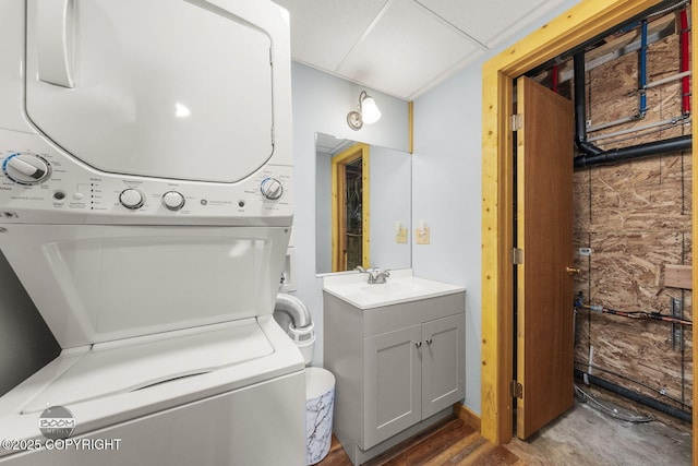 8153 Stewart Mountain Dr, Eagle River, AK 99577 - laundry area featuring stacked washing machine and dryer and wood finished floors