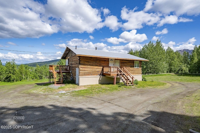 8153 Stewart Mountain Dr, Eagle River, AK 99577 - view of front of property featuring stairway, a wooden deck, and metal roof