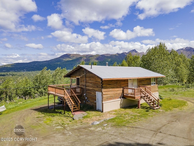 8153 Stewart Mountain Dr, Eagle River, AK 99577 - view of side of property featuring stairway, a deck with mountain view, and metal roof