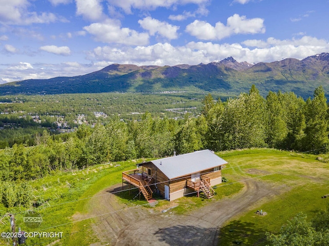 8153 Stewart Mountain Dr, Eagle River, AK 99577 - view of subject property with a mountainous background and a forest