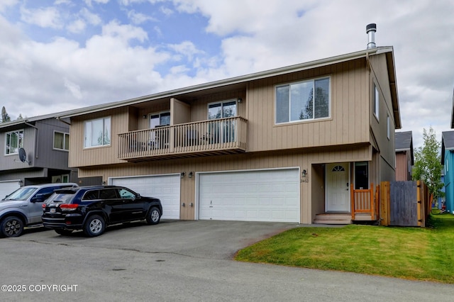 2460 Lochenshire Pl Unit 21, Anchorage, AK 99504 - view of property featuring asphalt driveway, a garage, and a front lawn