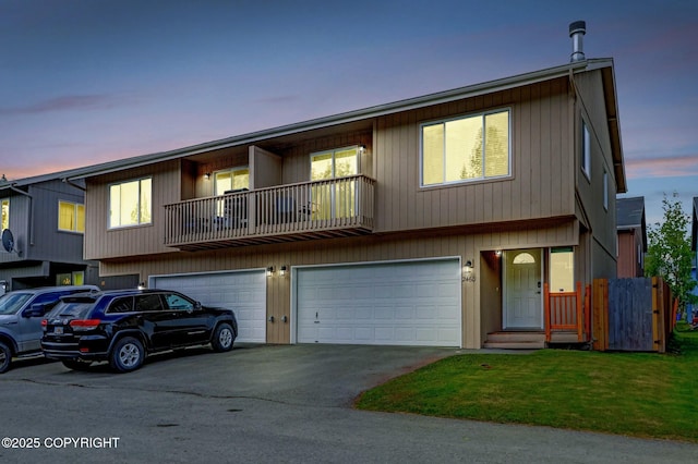 2460 Lochenshire Pl Unit 21, Anchorage, AK 99504 - view of property featuring driveway, a garage, a balcony, and a front yard