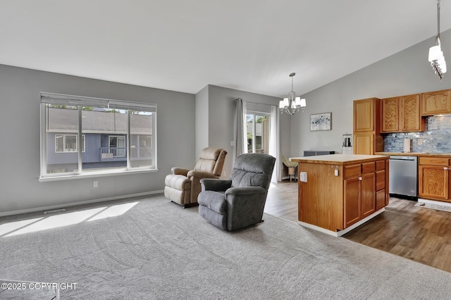 2460 Lochenshire Pl Unit 21, Anchorage, AK 99504 - kitchen with a chandelier, dishwasher, open floor plan, decorative backsplash, and a kitchen island