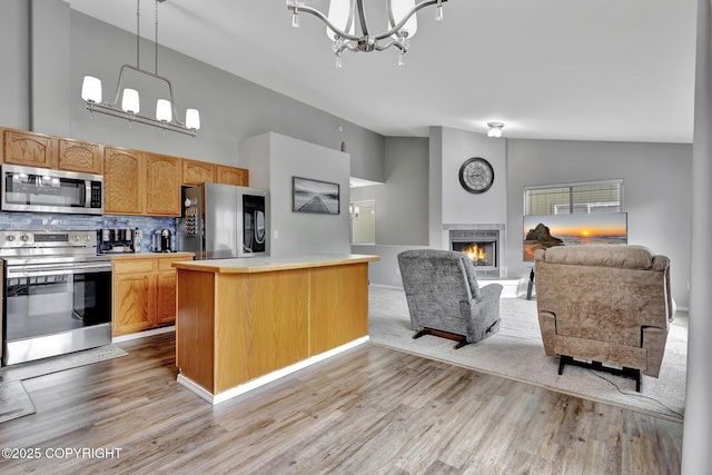 2460 Lochenshire Pl Unit 21, Anchorage, AK 99504 - kitchen with appliances with stainless steel finishes, a chandelier, light countertops, open floor plan, and light wood finished floors