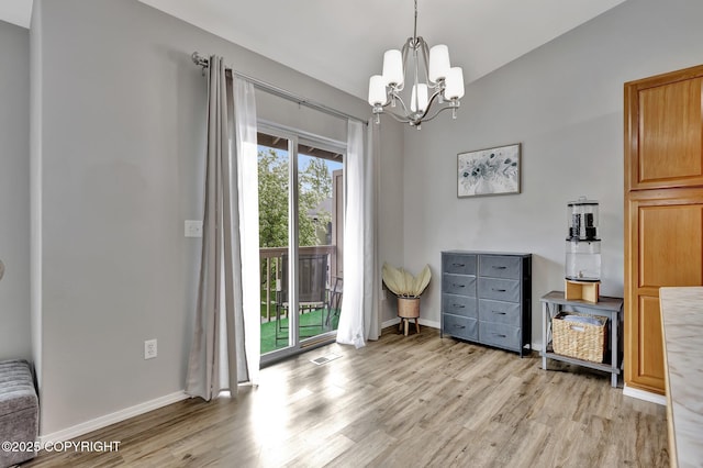 2460 Lochenshire Pl Unit 21, Anchorage, AK 99504 - dining room with light wood-style flooring, a chandelier, and baseboards
