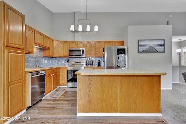 2460 Lochenshire Pl Unit 21, Anchorage, AK 99504 - kitchen with appliances with stainless steel finishes, a sink, a chandelier, and light countertops