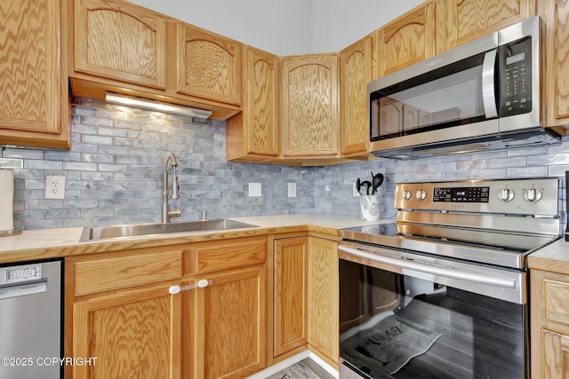 2460 Lochenshire Pl Unit 21, Anchorage, AK 99504 - kitchen with appliances with stainless steel finishes, a sink, light countertops, tasteful backsplash, and light brown cabinets
