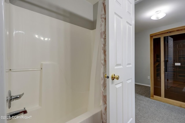 2460 Lochenshire Pl Unit 21, Anchorage, AK 99504 - bathroom with shower / bathtub combination with curtain and baseboards