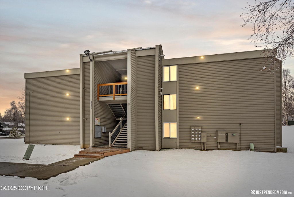 4620 Reka Dr # B8, Anchorage, AK 99508 - snow covered house with stairway and a balcony