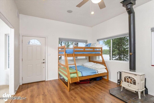 13598 N Willow Dr, Willow, AK 99688 - bedroom with wood finished floors, a wood stove, and baseboards