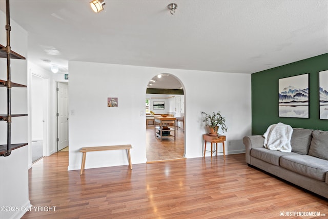 1602 Richardson Dr, Anchorage, AK 99504 - living area featuring arched walkways and light wood-style flooring
